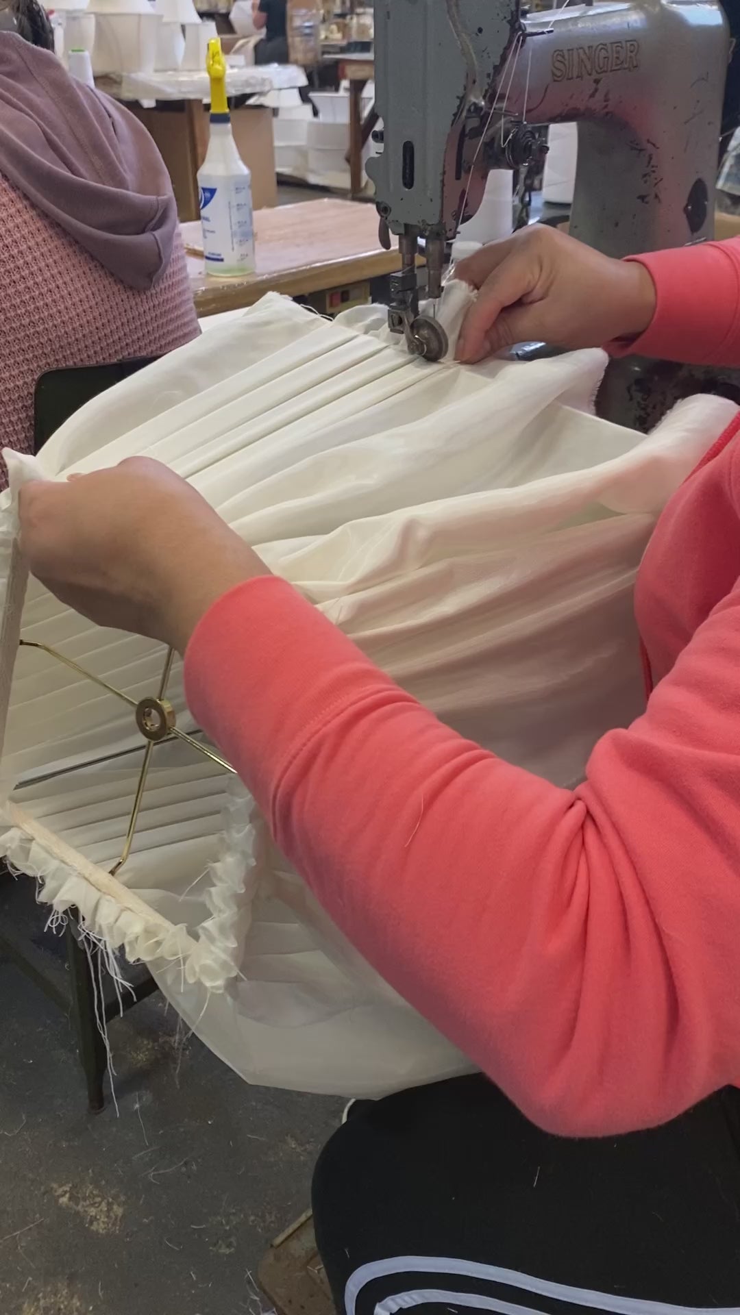 A woman working on a custom lamp shade