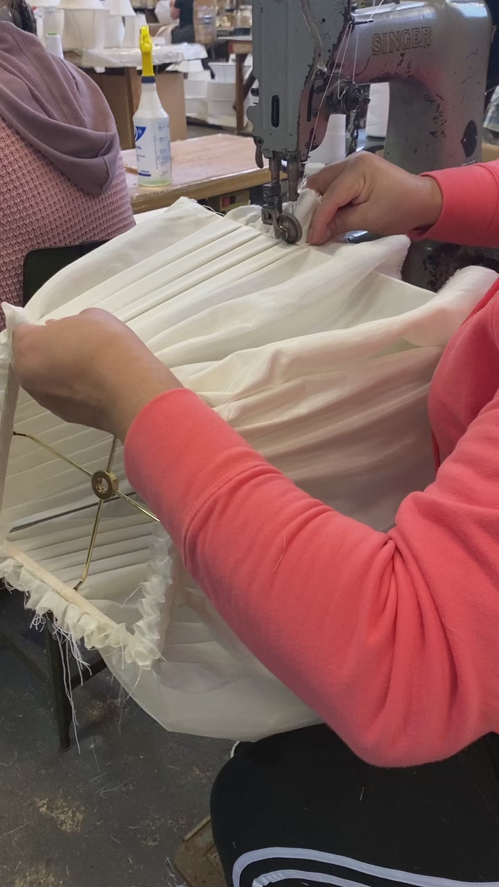 A woman working on a custom lamp shade