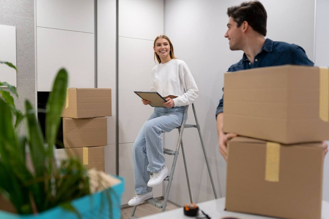 Couple discussing how to pack lampshades for moving. 