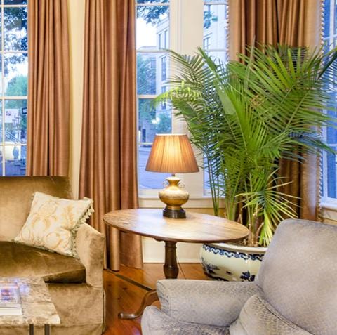 lamp and shade on table between couch and chair